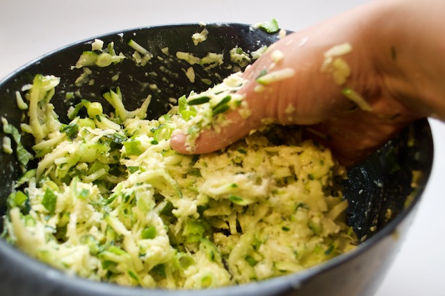 Hand-mixing the ingredients for the zucchini fennel fritters