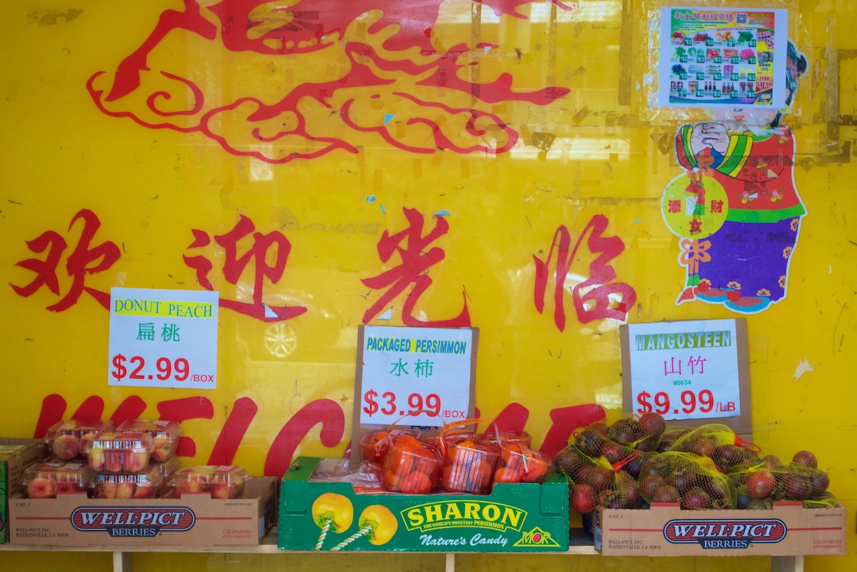 Fruit Stand behind yellow background in Elmhurst, Queens