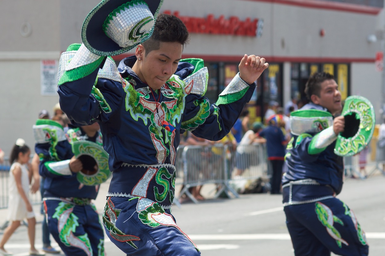 Dancers in Green along the Parade of the
                      Silleteros route in Northern Boulevard in Jackson Heights, Queens for the Festival de las Flores