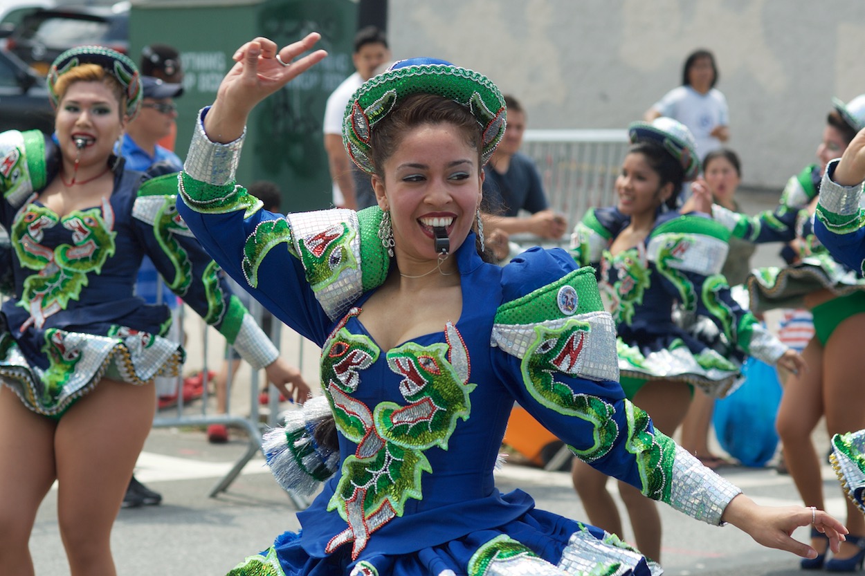 Dancers in Green along the Parade of the
                      Silleteros route in Northern Boulevard in Jackson Heights, Queens for the Festival de las Flores