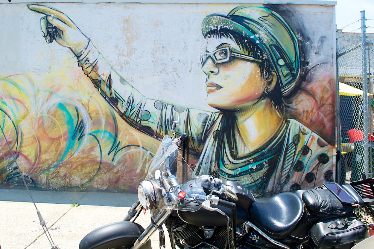 Street Mural of a Woman behind a Motorcycle in Rockaway, Queens