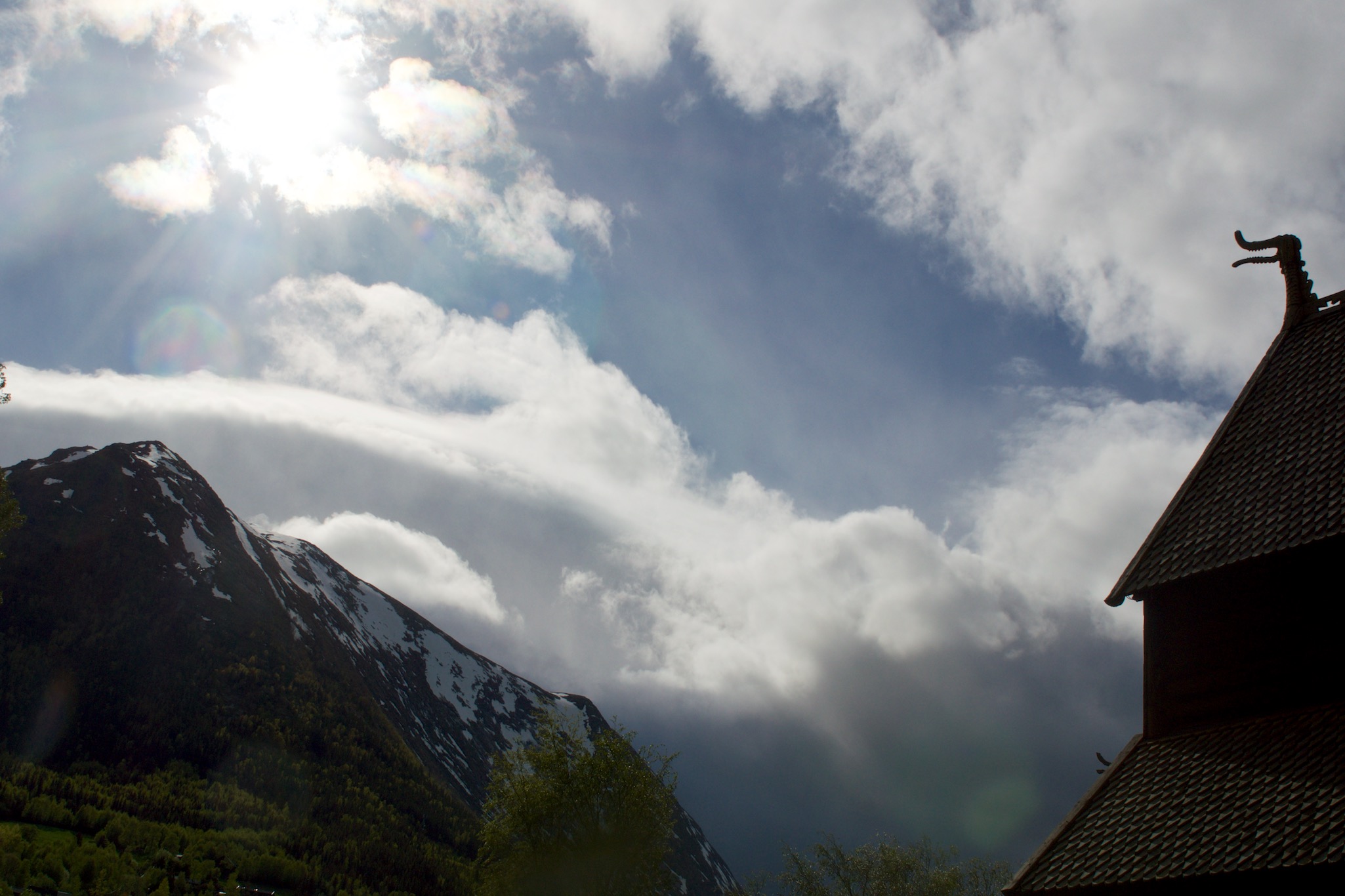 Detail from stave church and against a mountain in Lom, Norway