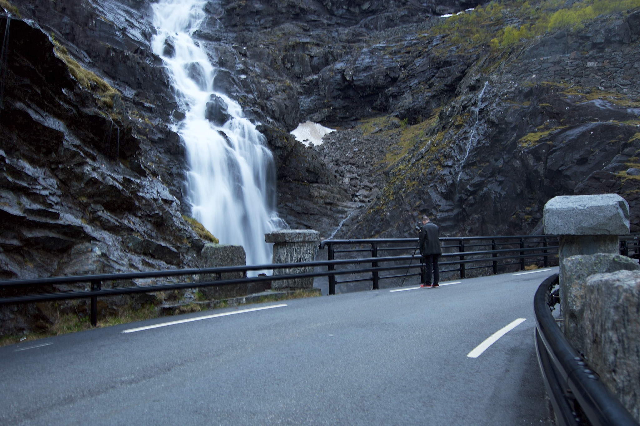 Taking photographs of a waterfall along the road in Trollstigen, Norway