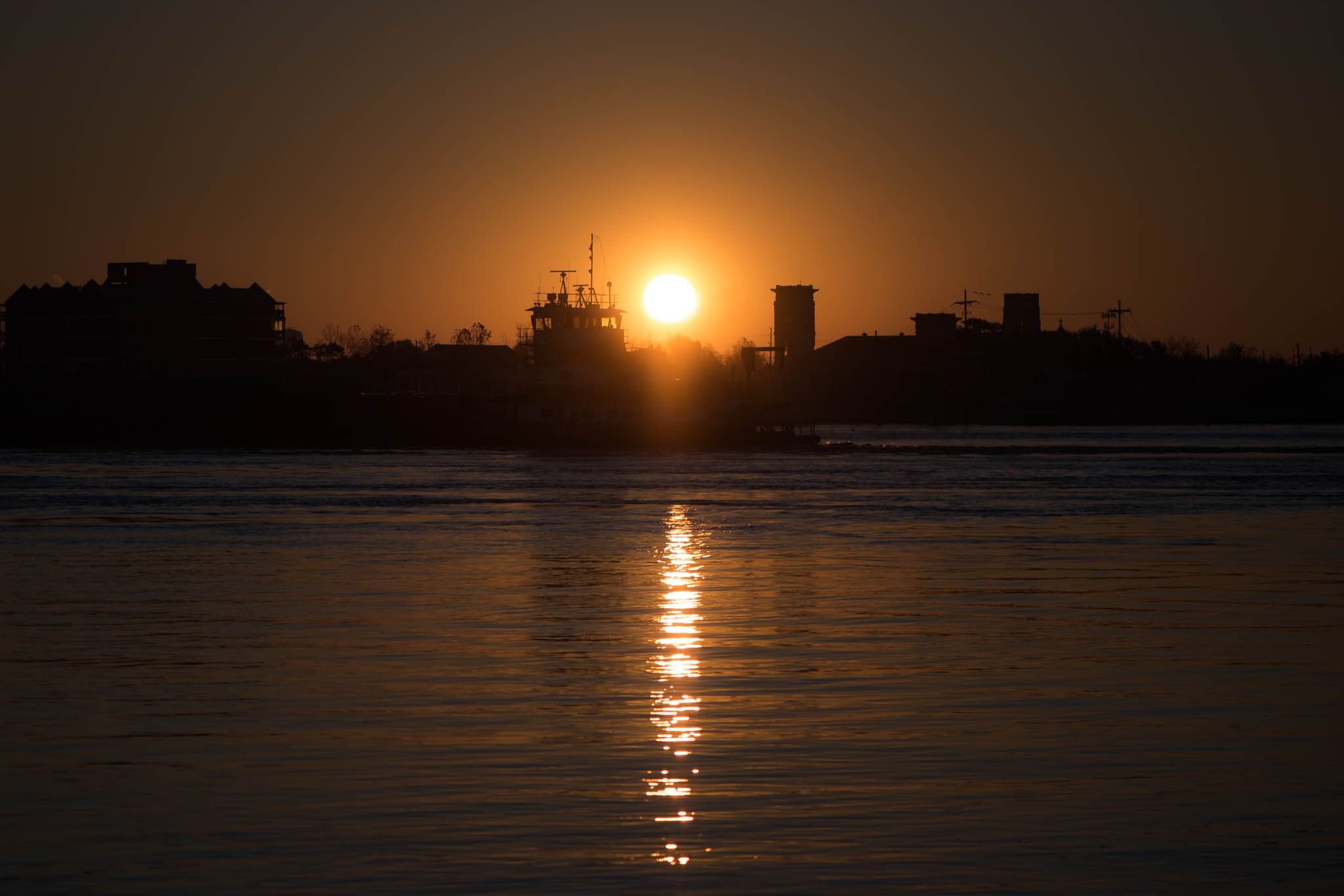 Sunrise and Boat on the Mississippi River in New Orleans, Louisiana, USA
